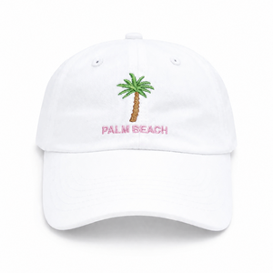 The Bits & Bows Palm Beach Hat is a girls’ white baseball cap featuring an embroidered green palm tree with “PALM BEACH” in pink lettering centered on the front—a fun and stylish accessory that adds a pop of color to any outfit.