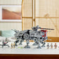 A LEGO® Star Wars AT-TE Walker from Legos - Toyhouse is prominently displayed on a white table, surrounded by a number of LEGO minifigures.