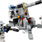 Four 501st Clone Troopers from the LEGO® Star Wars™ 501st Clone Troopers™ Battle Pack by Legos - Toyhouse, each with blue-marked armor and weapons, surround a gray AV-7 anti-vehicle cannon with legs.