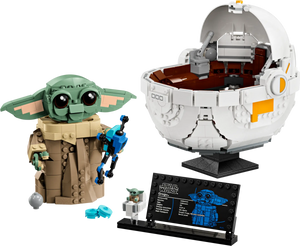 This LEGO Star Wars™ Grogu™ with Hover Pram by Legos - Toyhouse features a small green character, complete with a white pod and black plaque—a must-have for The Mandalorian fans!.