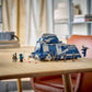 The Legos - Toyhouse LEGO® Star Wars™ Battle of Felucia Separatist MTT™ set, with minifigures and a blue-gray MTT, is displayed on a wooden table in a bright room, perfect for reenacting the epic battle.