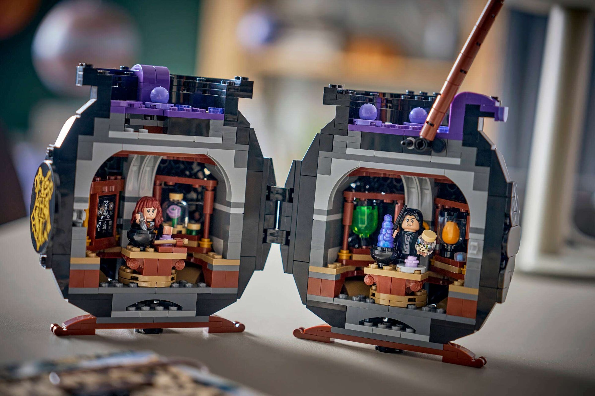 Open the Legos - Toyhouse Harry Potter™ Cauldron: Secret Potions Classroom set to reveal two potions classroom scenes with minifigures, potion bottles, and Harry Potter-themed decor in a circular, book-like case.