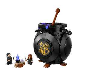 The Legos - Toyhouse Harry Potter™ Cauldron: Secret Potions Classroom set includes a large black Hogwarts cauldron, wooden stirrer, purple pieces, two minifigures, and a table with blue flames—ideal for any potions classroom or Harry Potter display.