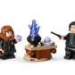 Two wizard minifigures from Legos - Toyhouse’s Harry Potter™ Cauldron: Secret Potions Classroom stand by a table with a cauldron, potion accessories, green jar, and blue animal—ideal for Harry Potter fans or room decor.