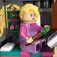 A LEGO® Harry Potter™ Luna Lovegood’s House set by Legos - Toyhouse features a blonde figure painting at a desk in a detailed, decorated room inspired by Luna’s enchanting home—perfect for imaginative play.