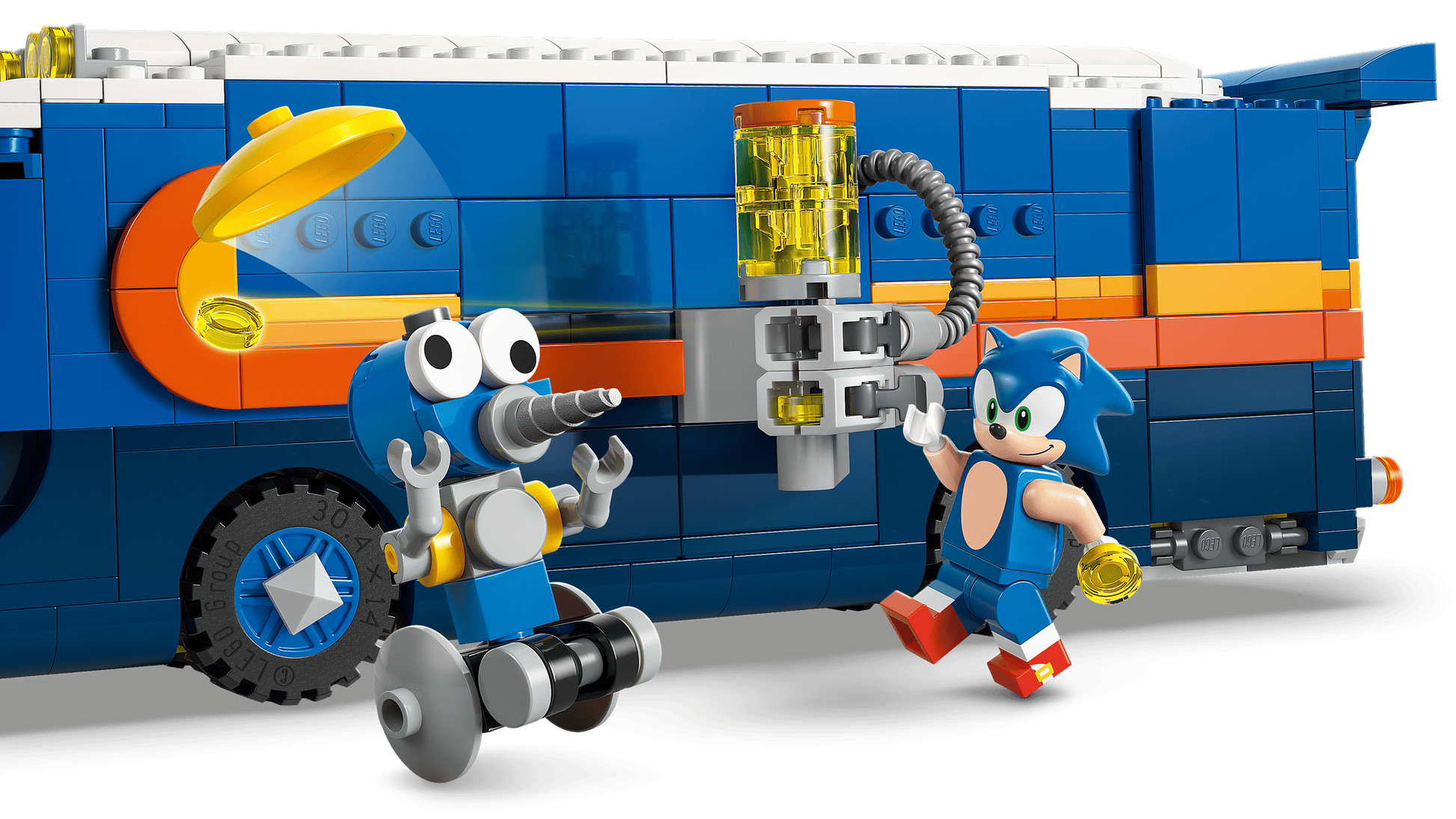LEGO® Sonic the Hedgehog™ and a blue robot stand by the colorful Legos - Toyhouse Team Sonic Command Truck, with yellow and orange features, as they explore its mechanical arm attachment.
