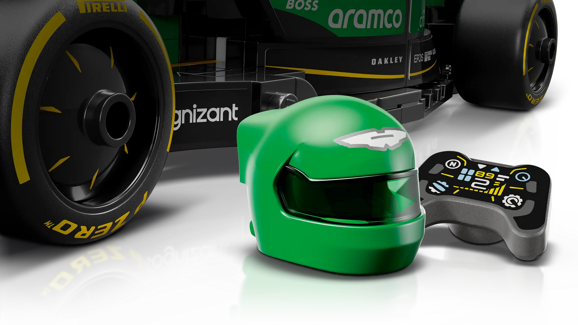 A green racing helmet and small black controller are in front of the rear wheel of a LEGO® Speed Champions Aston Martin Aramco F1® AMR24 Race Car by Legos - Toyhouse, with a bold black and green design.