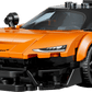 The Legos - Toyhouse LEGO® Speed Champions McLaren W1 set includes an orange race car toy, a smiling minifigure in a McLaren shirt, and a sleek black racing helmet.