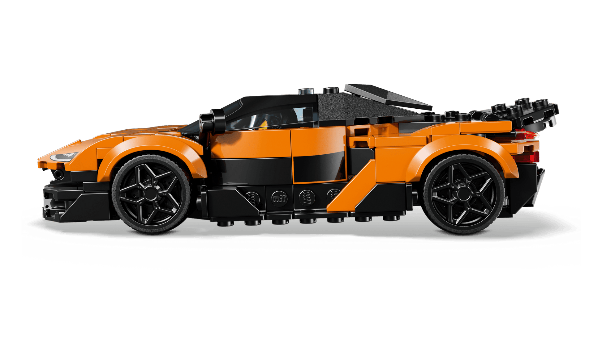 A LEGO® Speed Champions McLaren W1 by Legos - Toyhouse is displayed in a side profile view, featuring an orange and black race car toy set against a white background.