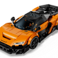 The LEGO® Speed Champions McLaren W1 by Legos - Toyhouse features orange and black styling, detailed headlights, black wheels, and a "McLaren" hood logo, shown from a dynamic front-side angle.
