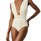 A person wearing the Lenny Niemeyer Chic One Piece swimsuit in cream, featuring a deep V-neck and wide straps with biodegradable UPF 50+ UV protection.