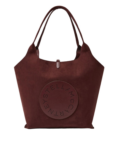 Stella McCartney Logo Reversible Suede Tote in large brown, featuring double handles and a circular patch with perforated “Stella McCartney” text on the front.