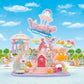 Create your own sea-themed amusement park adventure with the Calico Critters Baby Mermaid Castle playset, featuring adorable baby figures, animal figurines, a pink mermaid castle, ship, carousel, fish, submarine, and ocean-inspired decorations—all set against a vibrant blue sky background.