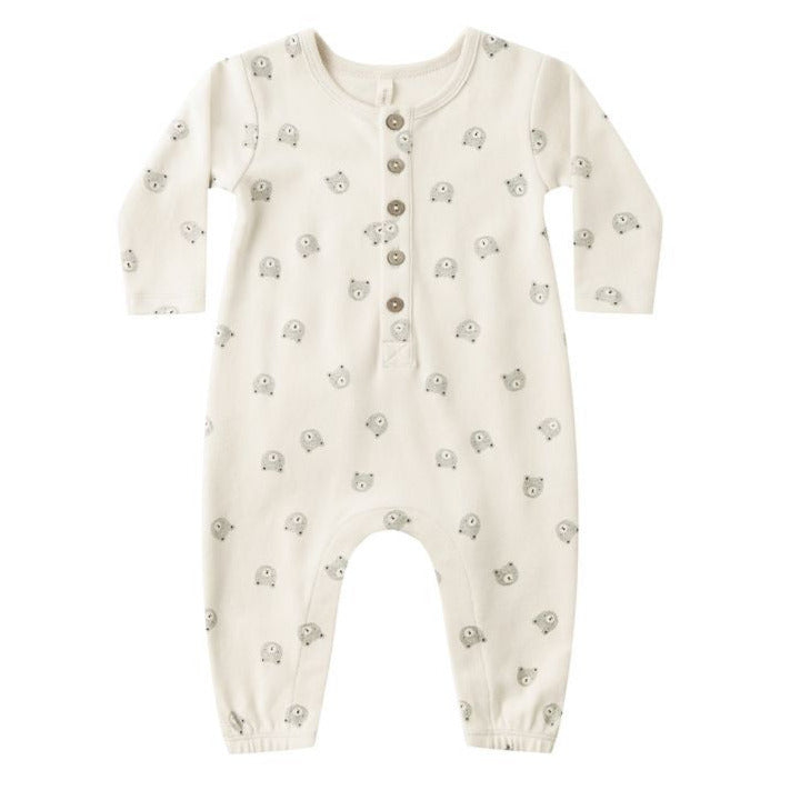The Quincy Mae Baby Long Sleeve Jumpsuit features a cream color, small bear face prints, and a button-up front with coconut buttons.