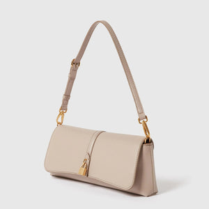 The Stella McCartney Ryder Pouchette Shoulder Bag is a beige luxury vegan accessory with a gold buckle and clasp, showcasing a short adjustable strap and a rectangular flap closure, presented against a plain white background.