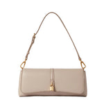 The Ryder Pouchette Shoulder Bag by Stella McCartney is a beige, rectangular luxury vegan bag featuring gold hardware, an adjustable strap, and a small gold padlock accent on the front flap, set against a white background.