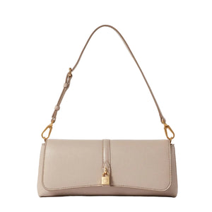 The Ryder Pouchette Shoulder Bag by Stella McCartney is a beige, rectangular luxury vegan bag featuring gold hardware, an adjustable strap, and a small gold padlock accent on the front flap, set against a white background.