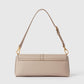 The Stella McCartney Ryder Pouchette Shoulder Bag is a small, rectangular beige luxury vegan bag, featuring a top handle, gold-tone hardware, and a fold-over flap, displayed against a plain white background.