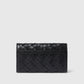 The Stella McCartney Stella Woven Ryder Wallet with Strap features a black woven design and a sleek rectangular shape, shown against a plain light background.