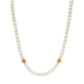 The Juliska Capucine De Wulf Berry Single Strand Necklace features lustrous white pearls with two gold bead accents, evenly spaced for a classic look, shown on a white background.