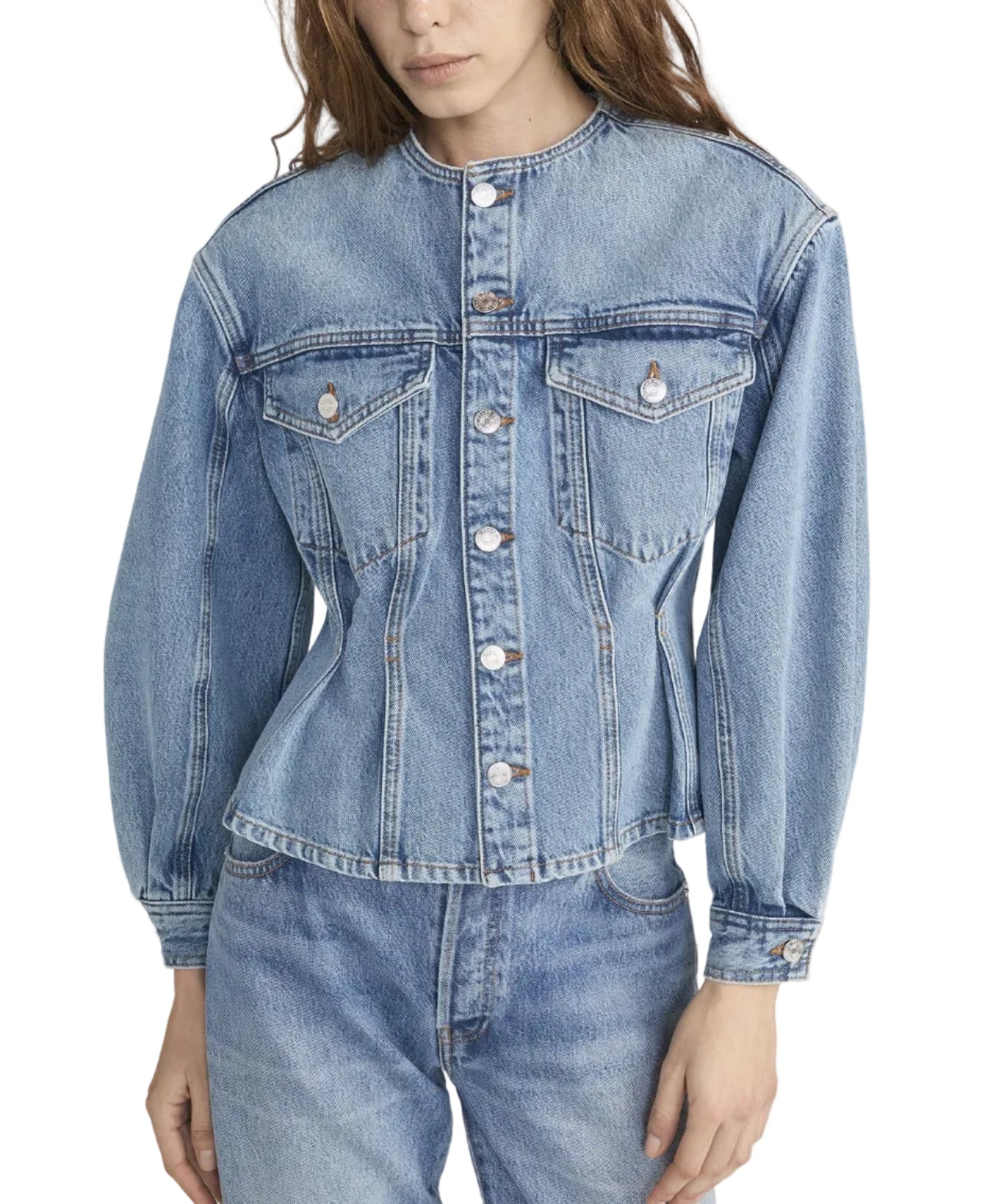 A woman wears the Frame Nipped Collarless Jacket in light blue cotton denim with front buttons, paired with matching jeans, photographed from mid-thigh up.