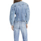 Model wearing The Nipped Collarless Jacket by Frame, shown from the back with jeans against a white background.