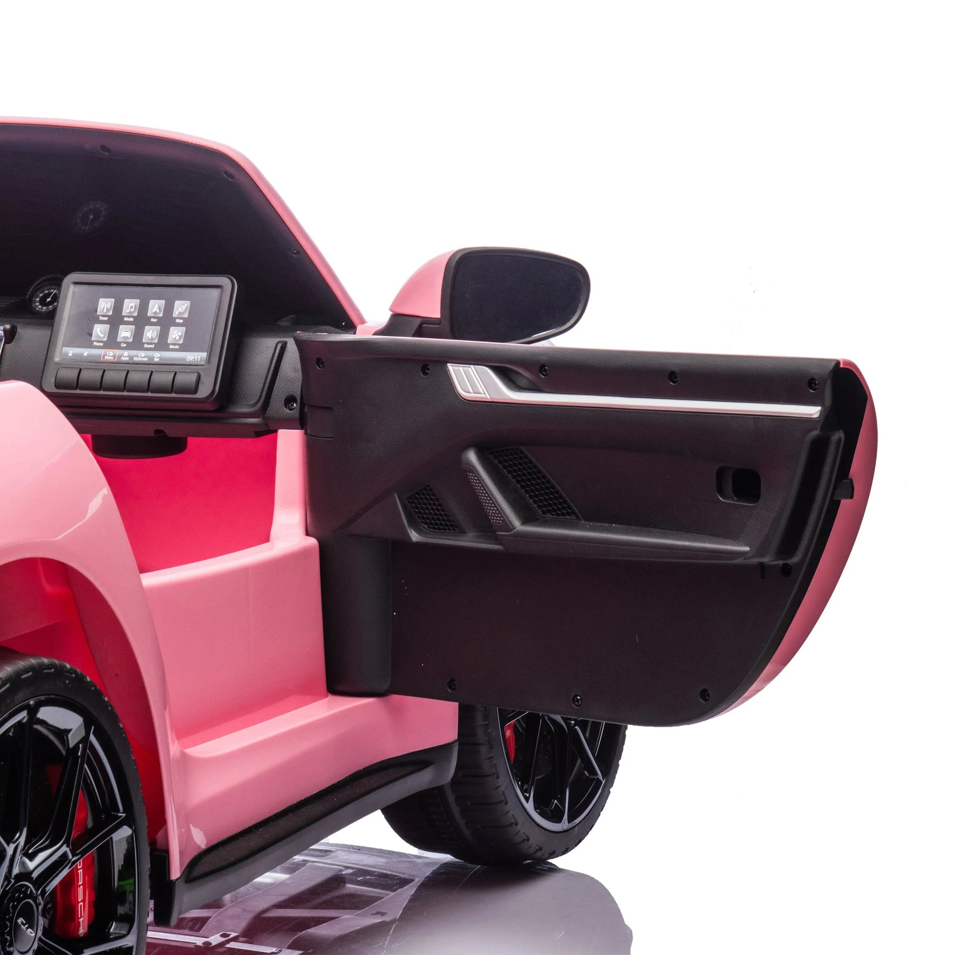 A close-up of the open driver’s side door of the Freddo 24V Porsche 911 GT3 Pink 2 Seater Ride-On, displaying the dashboard, side mirror, and part of the wheel against a white background.