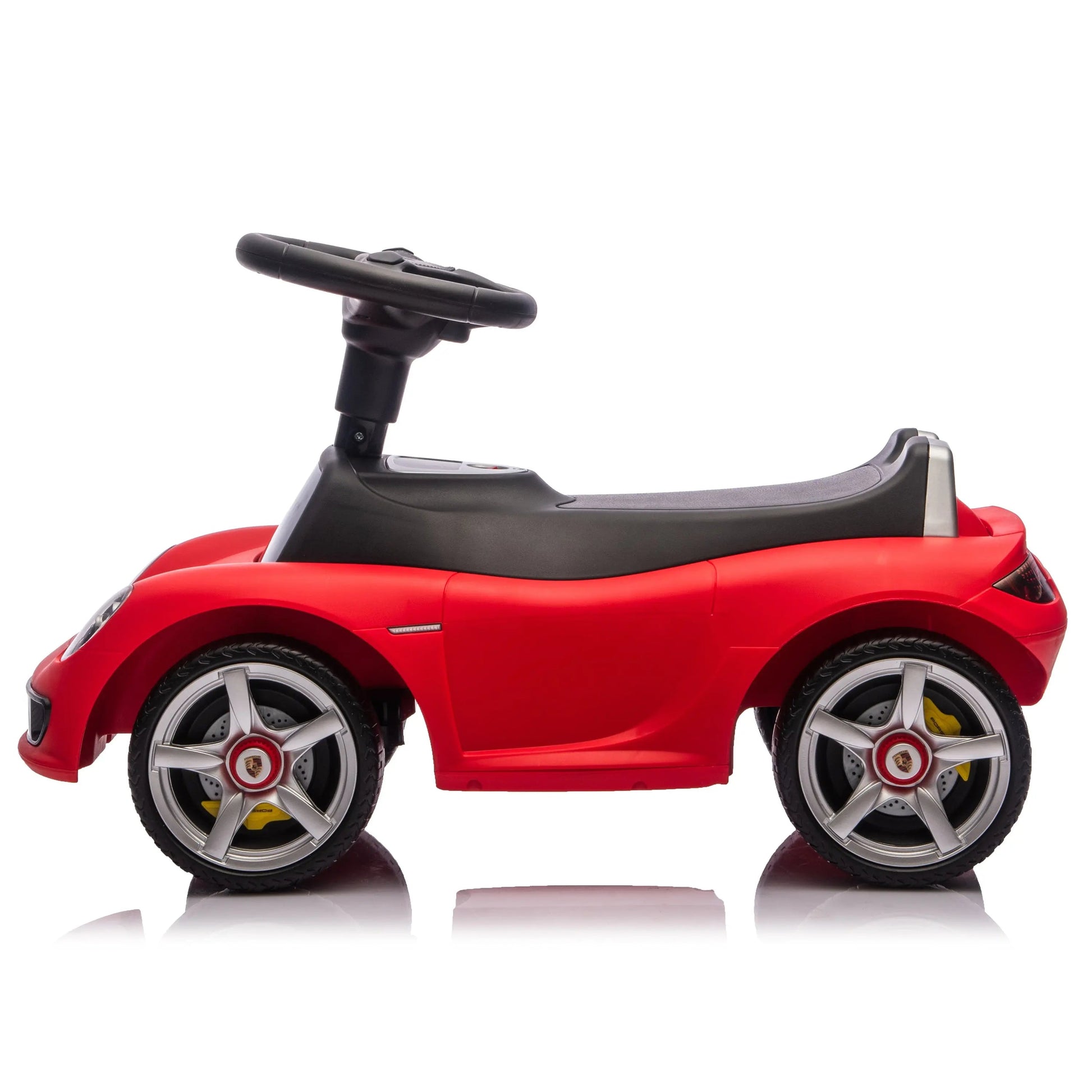 Freddo Porsche 911 Carrera GT Foot-to-Floor Ride-On, featuring four wheels and a black seat, displayed in side profile against a white background.