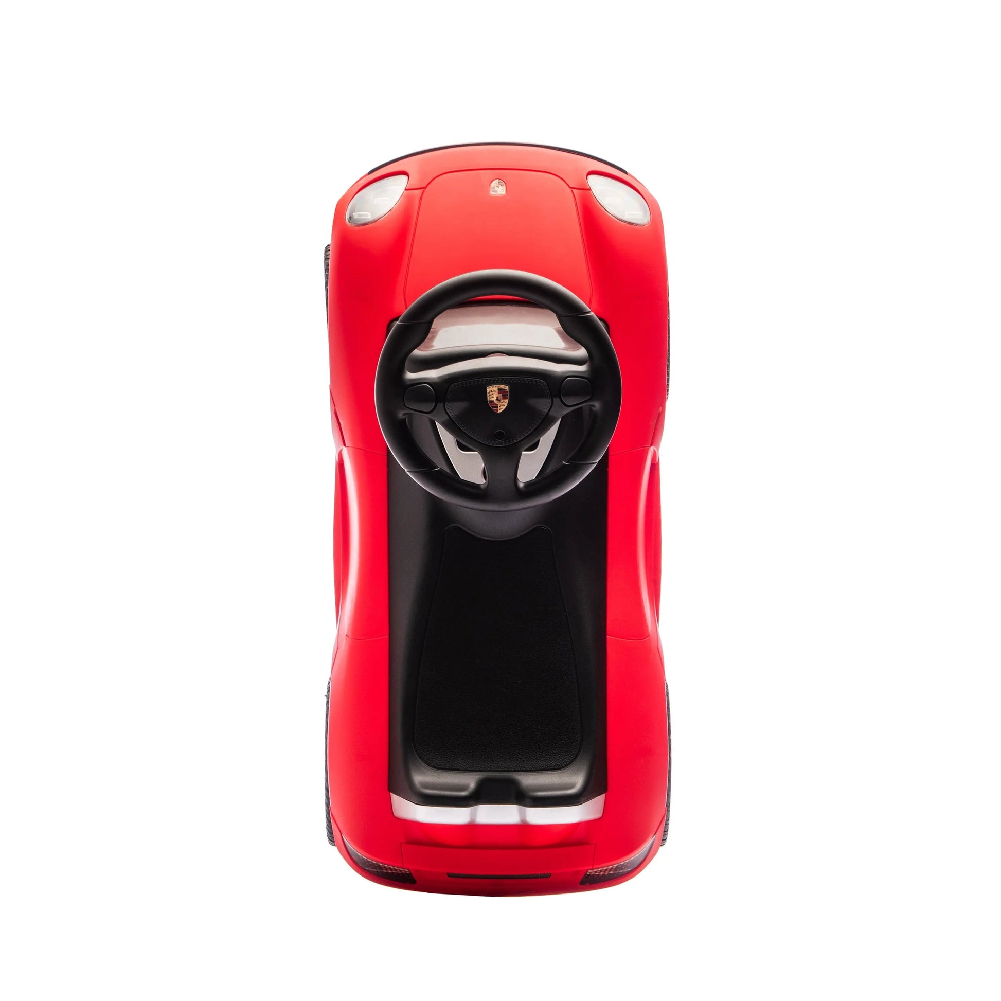 Top view of a small red Freddo Porsche 911 Carrera GT Foot-to-Floor Ride-On toy car with a steering wheel, resembling a sports car, on a white background.