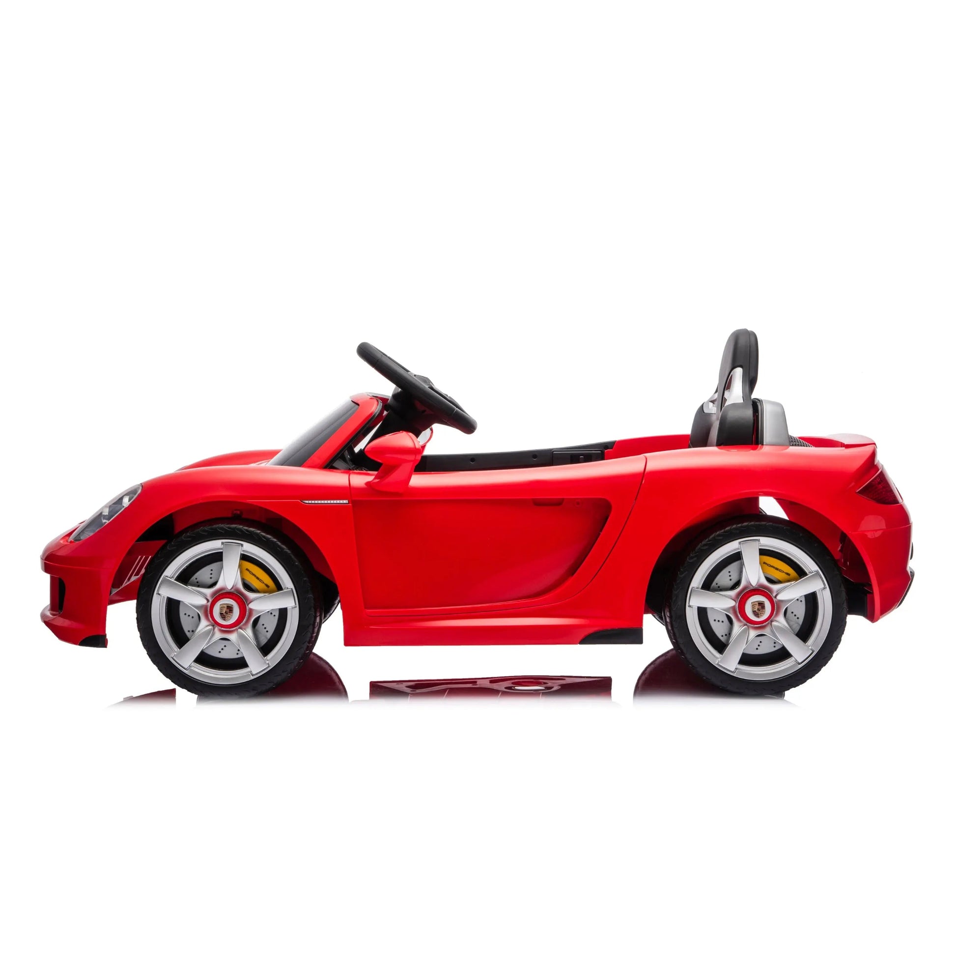 The Freddo 12V Porsche Carrera GT 1 Seater Ride-On, shown in red with a black interior, silver wheels, and a visible steering wheel, is displayed in profile against a white background; this motorized vehicle also includes a parental remote control for enhanced safety and convenience.