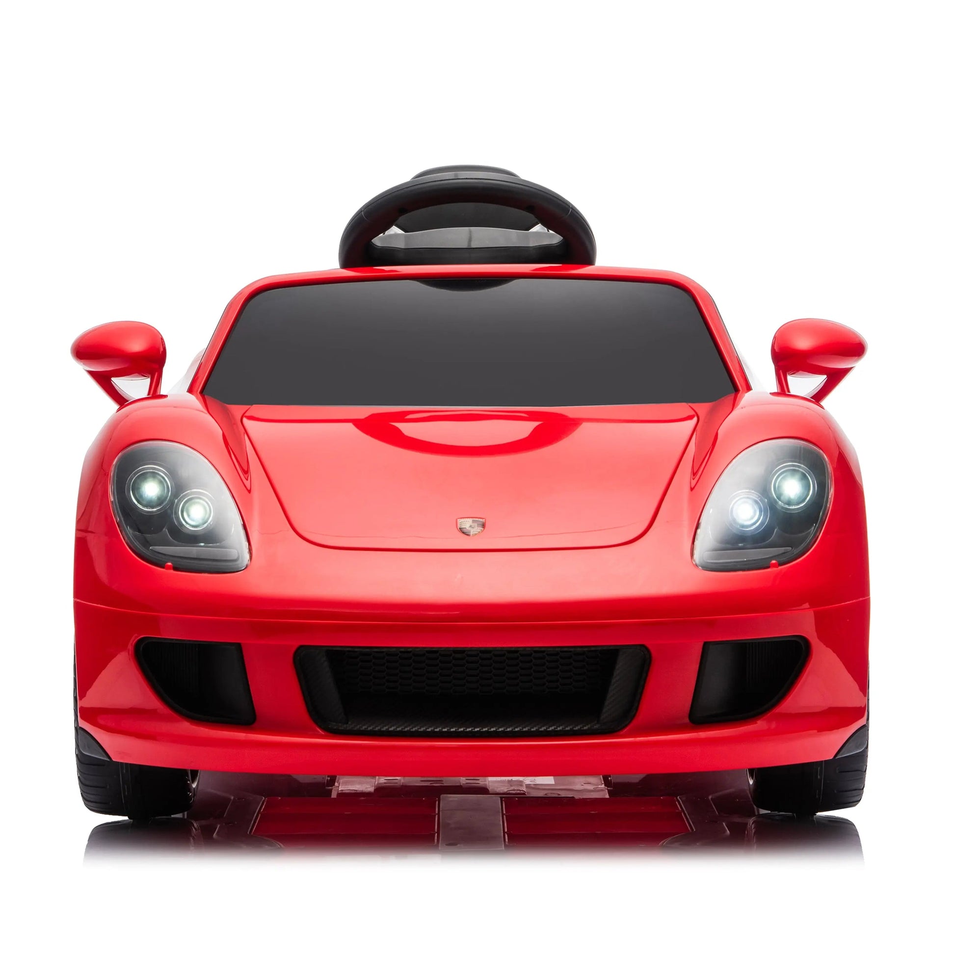 Front view of a red Freddo 12V Porsche Carrera GT 1 Seater Ride-On with headlights illuminated, styled to resemble a real sports car, displayed against a plain white background. This motorized ride-on features an authentic design and includes parental remote control for enhanced safety and convenience.
