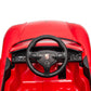 Overhead view of the dashboard and steering wheel of the Freddo 12V Porsche Carrera GT 1 Seater Ride-On, highlighting control buttons and the classic Porsche logo at the center. This motorized vehicle comes with a parental remote control for enhanced safety and convenience.