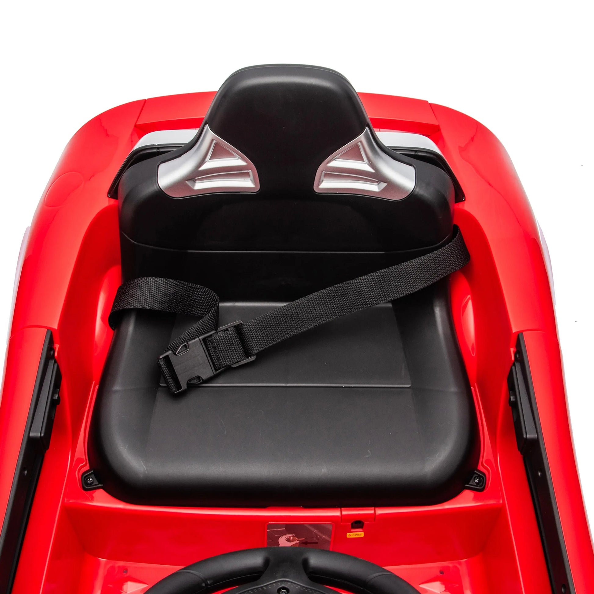 Red seat with a black backrest, silver details, and a secure black seatbelt—specially designed for the Freddo 12V Porsche Carrera GT 1 Seater Ride-On Car—shown from above against a white background. Ideal for any young driver’s 12V motorized vehicle, this seat combines comfort and style.