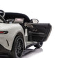 Partial view of the Freddo 24V Mercedes AMG GT63 Gray 2 Seater Ride-On with the driver’s side door open, revealing the interior dashboard, steering wheel, and touchscreen display against a white background.