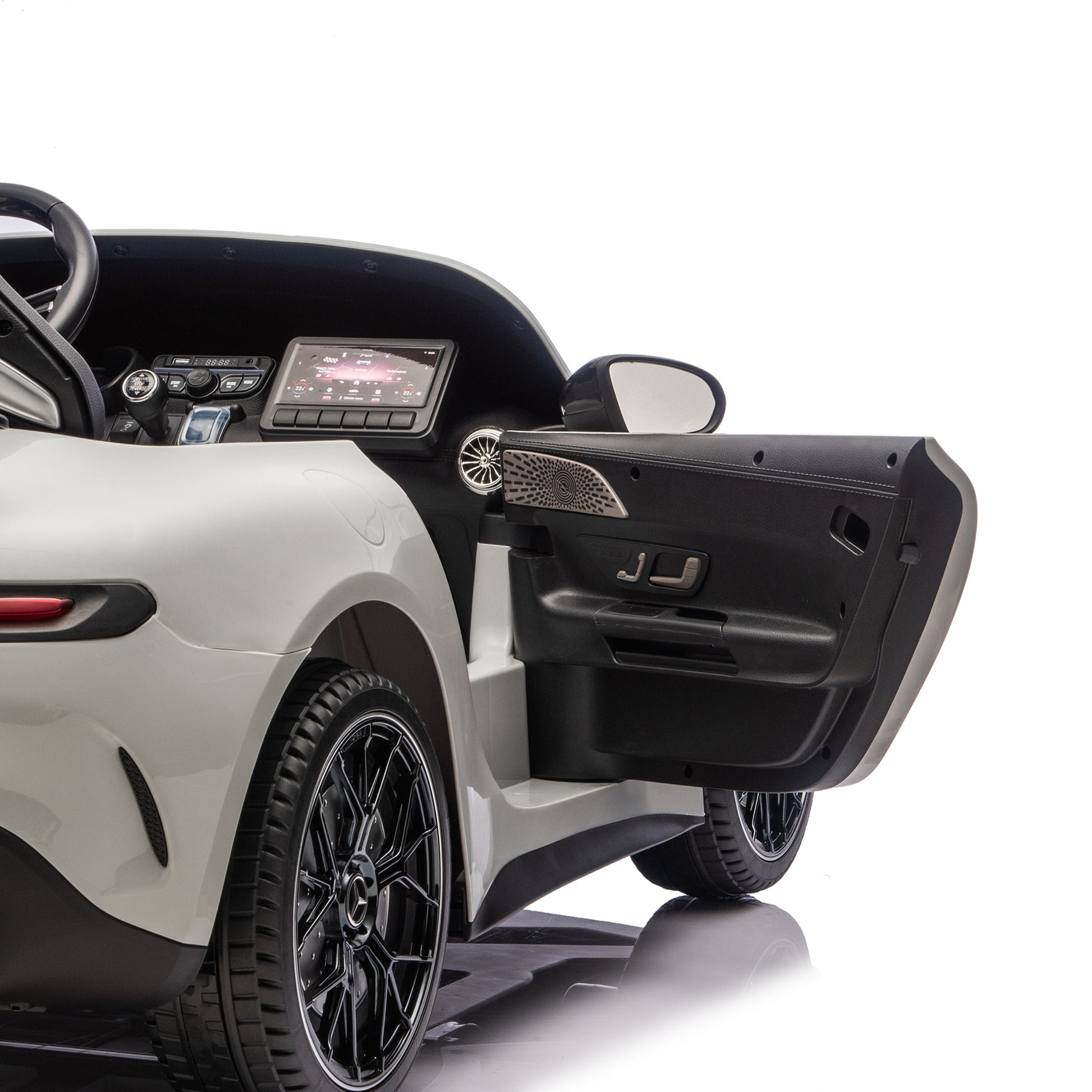 Partial view of the Freddo 24V Mercedes AMG GT63 Gray 2 Seater Ride-On with the driver’s side door open, revealing the interior dashboard, steering wheel, and touchscreen display against a white background.
