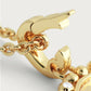 Close-up of the Anabel Aram Pegasus Gold Coin Charm, a gold chain necklace with a decorative pendant and small clear gemstone, featuring a mythical Pegasus-inspired design.