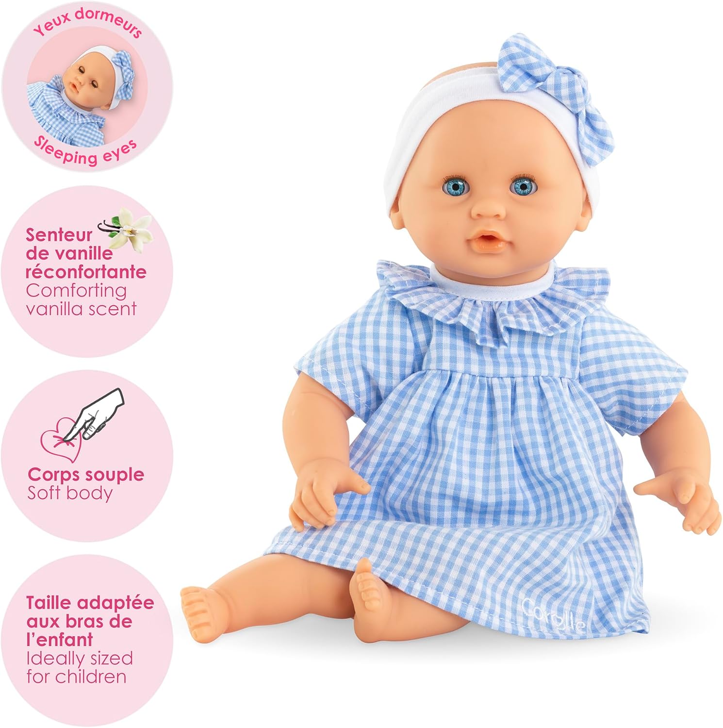 Corolle’s Premier Calin - Milly Doll is a cuddly first baby doll with blue eyes, a blue and white checkered dress, headband, vanilla scent, sleeping eyes, soft body, and child-sized proportions—perfect for little ones.