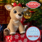 A plush Clarice reindeer toy with a red bow sits on wrapped gifts under an ornamented Christmas tree. Text reads, "Clarice," "Kids Preferred," and "Super Soft Cuddly Plush!"—a true Christmas classic.
