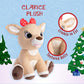 The Kids Preferred Clarice Plush, inspired by Rudolph, features a red bow, crinkly ear, and textured belly, and sits adorably between two decorated Christmas trees.