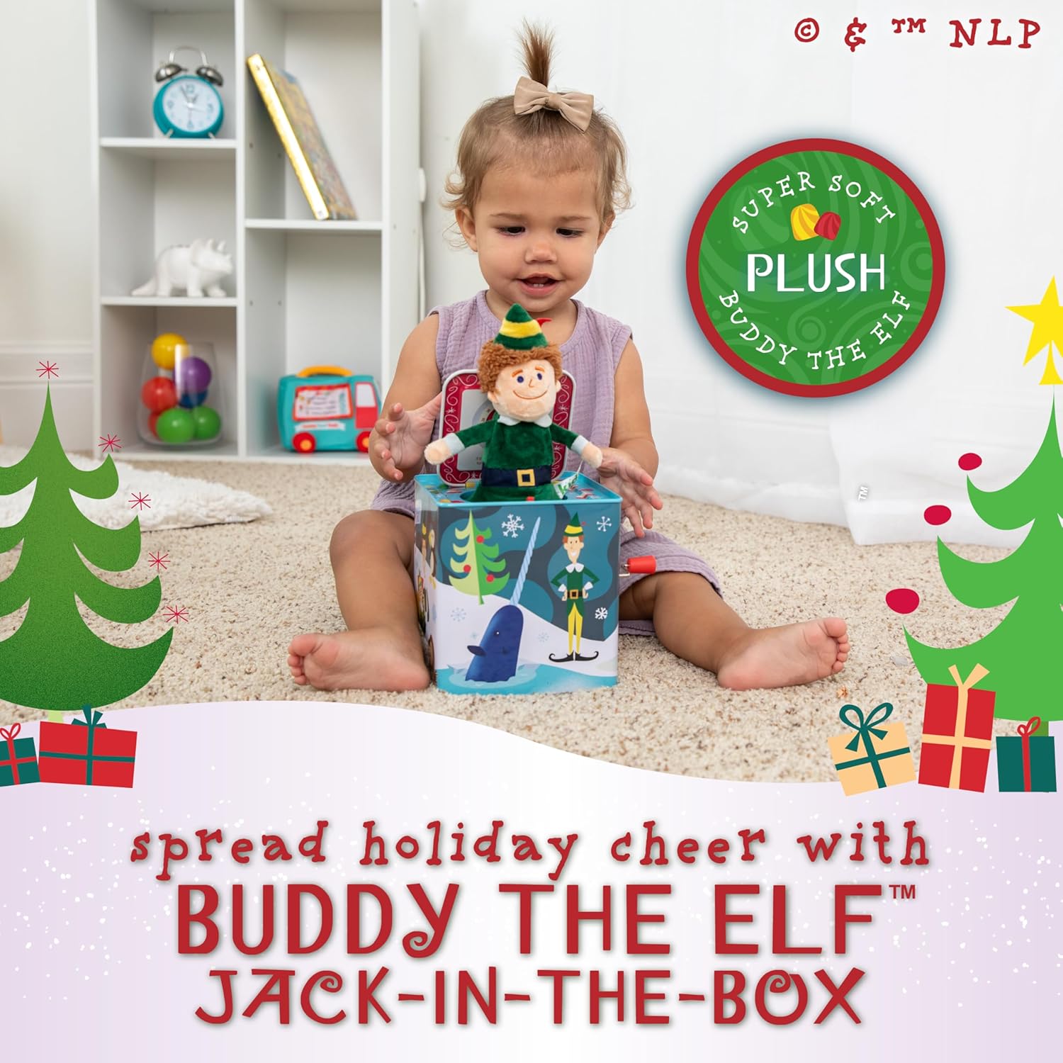 A young child plays on a carpeted floor with the Kids Preferred Elf Jack-in-the-Box in a festively decorated room featuring holiday graphics and promotional text.