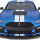 Front view of a blue 1:18 SE 2020 Mustang Shelby GT500 with white racing stripes and a cobra emblem on the grille, expertly crafted by Maisto as a die-cast collectible vehicle.