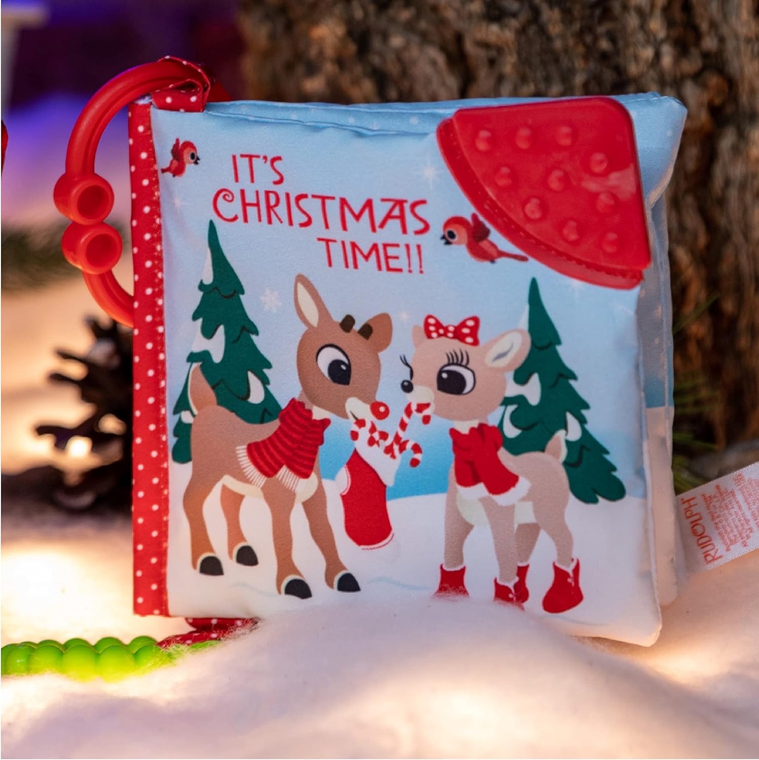 The Kids Preferred Rudolph Soft Book is a sensory baby activity toy with cartoon reindeer, trees, festive "IT'S CHRISTMAS TIME!!" text, and a wintry background—perfect for little ones.