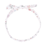 The Angel Dear Knot Headband is a fabric accessory adorned with a delightful floral print, featuring a knotted bow on top and an elastic back for a secure fit. Designed as the perfect baby headband, it offers both comfort and cuteness for little ones.