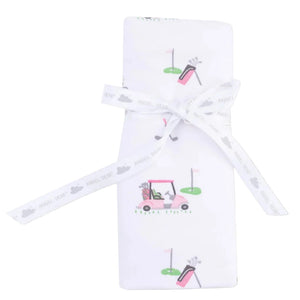 The Angel Dear Baby Golf Carts Ruffle Burp Cloth features a white fabric with golf cart and bag prints, folded and tied with a white ribbon displaying "ANGEL DEAR" and cloud motifs.
