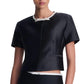 Simkhai Naelle top: a structured black short-sleeved shirt featuring a white round neckline with a bow detail and a matching bow at the waist.