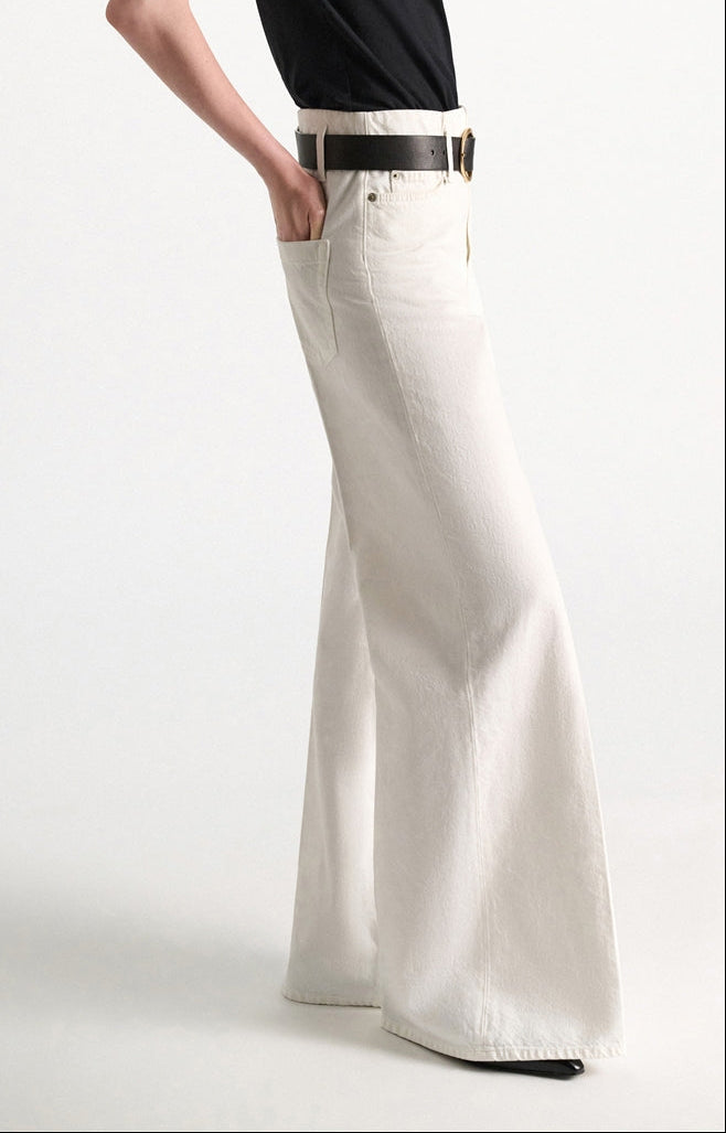 Side view of off-white, wide-leg Dorothee Schumacher Denim Attraction Pant styled with a dark belt.