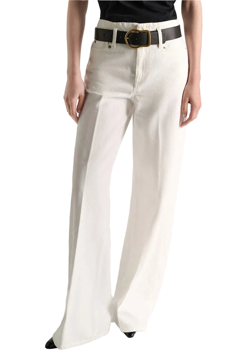 Dorothee Schumacher Denim Attraction Pant in white wash, featuring a high-waisted, wide-leg cut worn with a black belt.