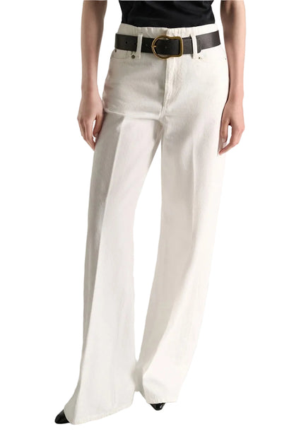 Dorothee Schumacher Denim Attraction Pant in white wash, featuring a high-waisted, wide-leg cut worn with a black belt.