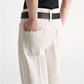 Off-white, wide-leg Dorothee Schumacher Denim Attraction Pant worn with a black belt and a hand in the back pocket.