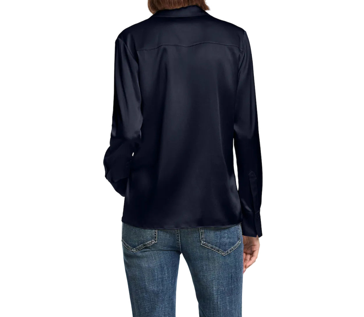 A person is shown from behind wearing the Dorothee Schumacher Sense of Shine Blouse, a fitted stretch silk satin top with a classic collar, paired with blue denim jeans against a plain white background.